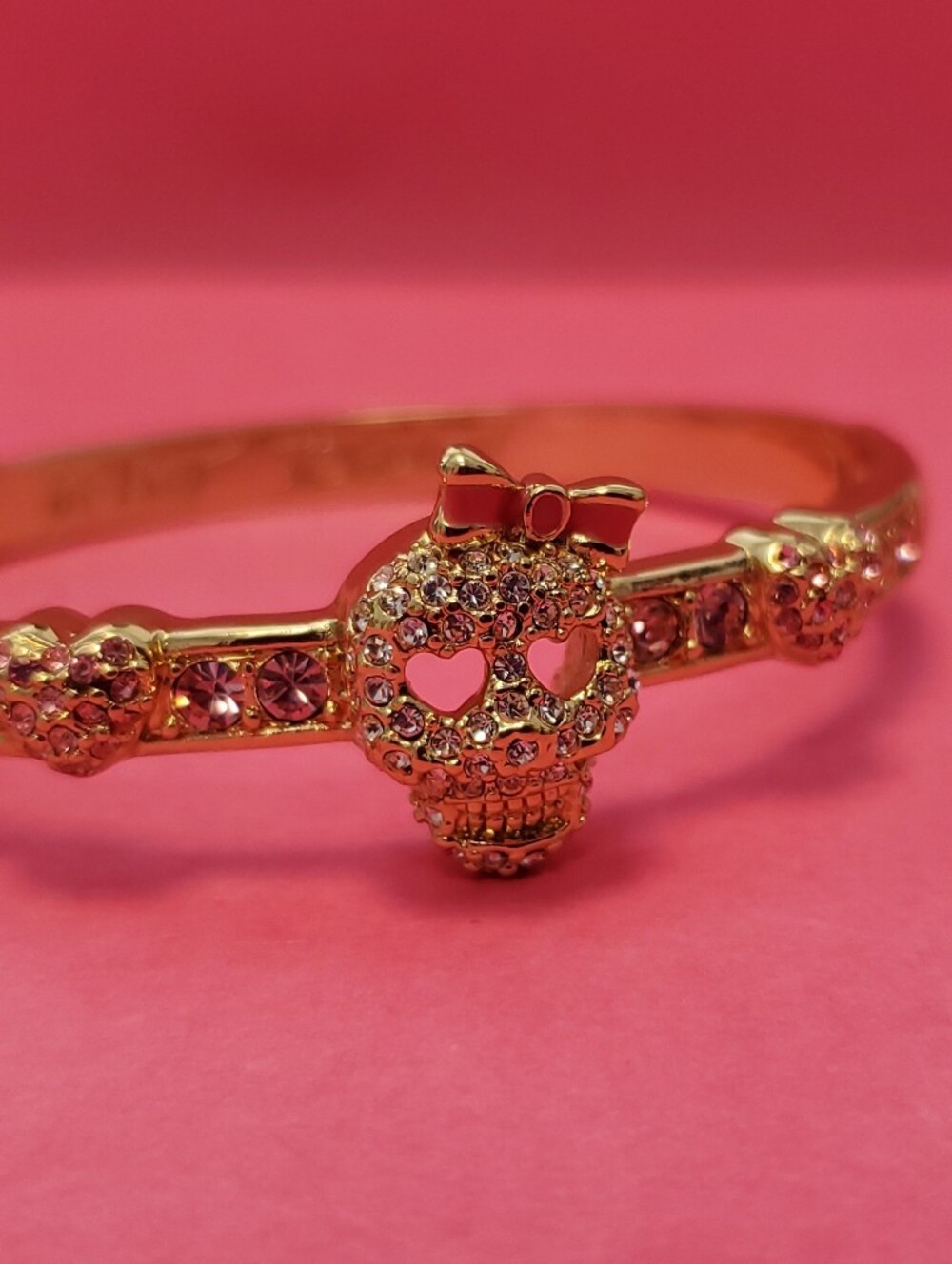 Betsey Johnson Gold-Tone Pink Crystal Skull Bangle with Bow Accent